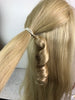 WRAPSTER - AN ELASTIC-LOOP PONY TAIL MAKER WITH PRE-CURLED SYNTHETIC HAIR TO WRAP THE ATTACHMENT